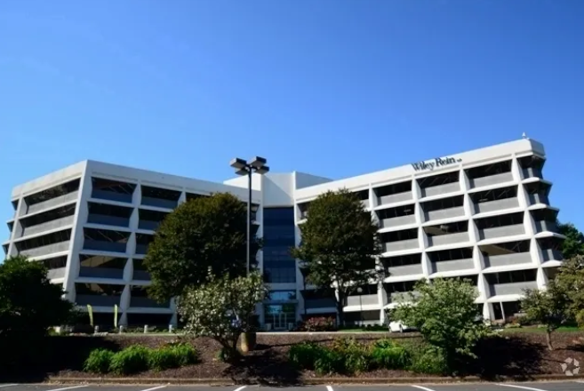 A white building surrounded by trees